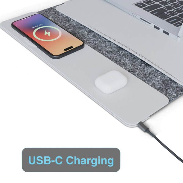 USB-C charging pad with phone and earbuds.