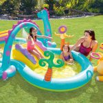 Children playing in dinosaur-themed inflatable pool