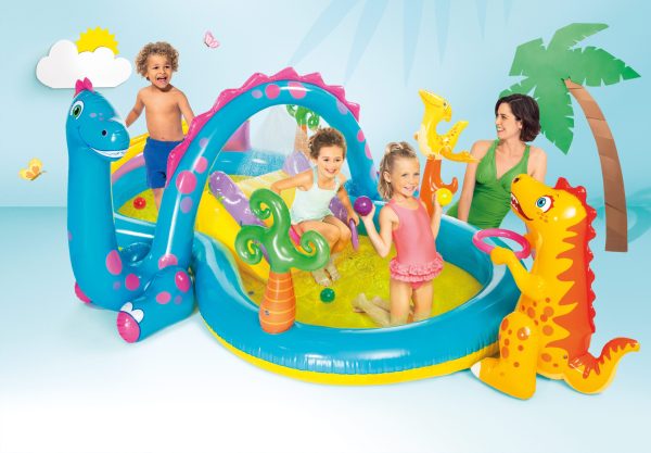 Kids playing in colourful inflatable dinosaur pool.