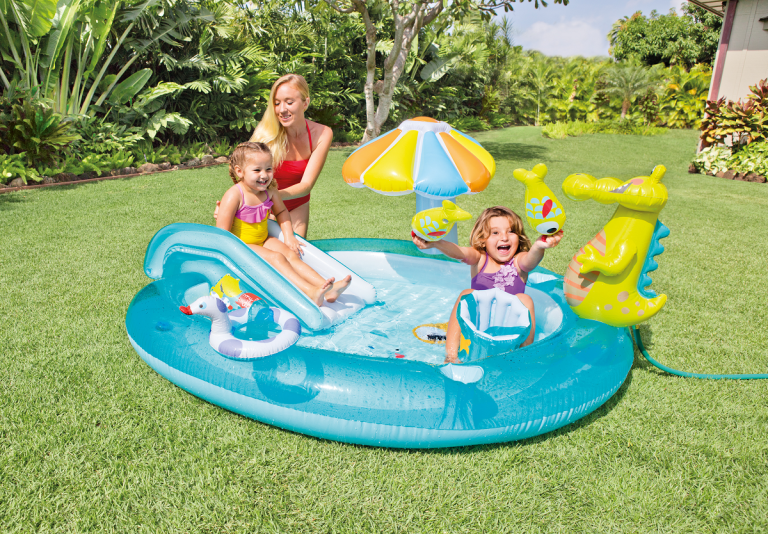 Kids playing in inflatable pool with toys.