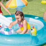 Child playing in inflatable backyard pool