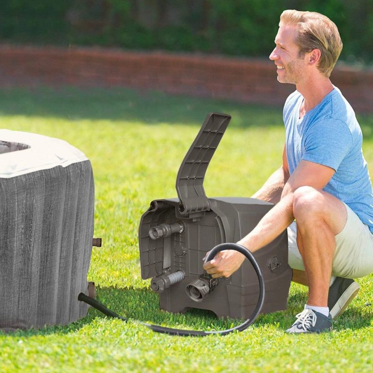 intex purespa 6 person greywood spa 28442 Man setting up inflatable hot tub outdoors.