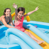 Woman and girl enjoying inflatable pool slide.