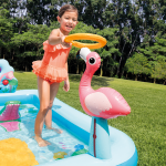 Child playing with inflatable flamingo pool toy