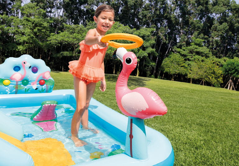 Child playing with inflatable flamingo pool toy
