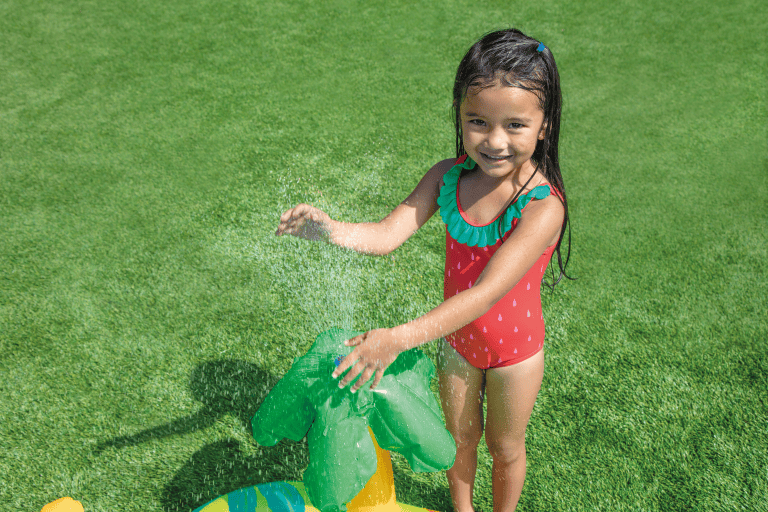 intex little dino inflatable play centre 57166 Girl playing with water sprinkler on grass