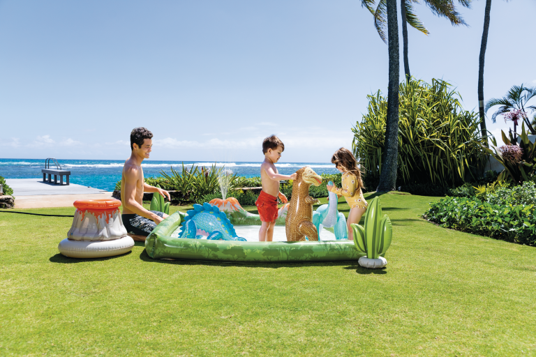 intex jurassic adventure inflatable play center 56132 Kids playing in inflatable pool by the beach.