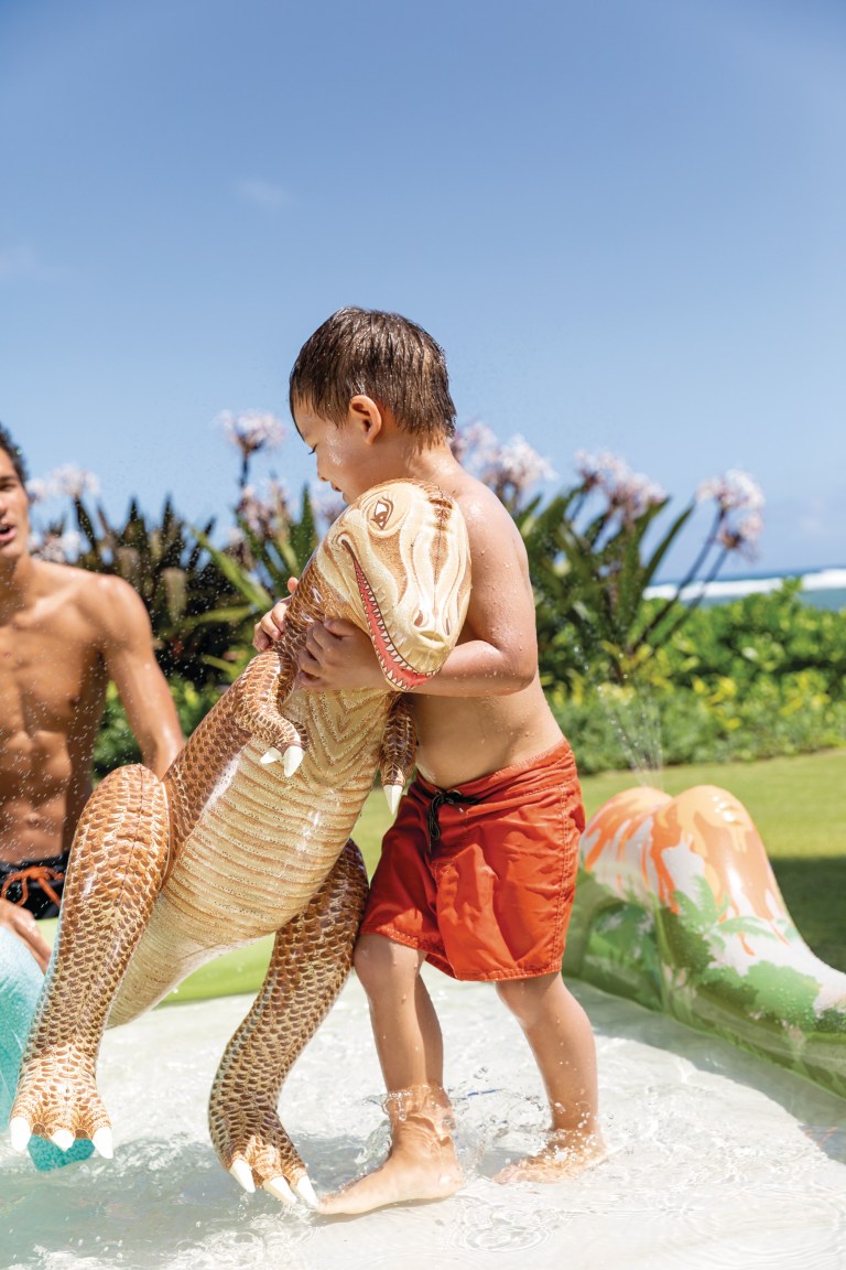 intex jurassic adventure inflatable play center 56132 Child in pool with inflatable dinosaur toy.