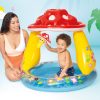 intex mushroom inflatable kiddie pool 57114 Child plays in colourful mushroom inflatable pool.
