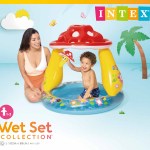 Child playing in inflatable mushroom pool.