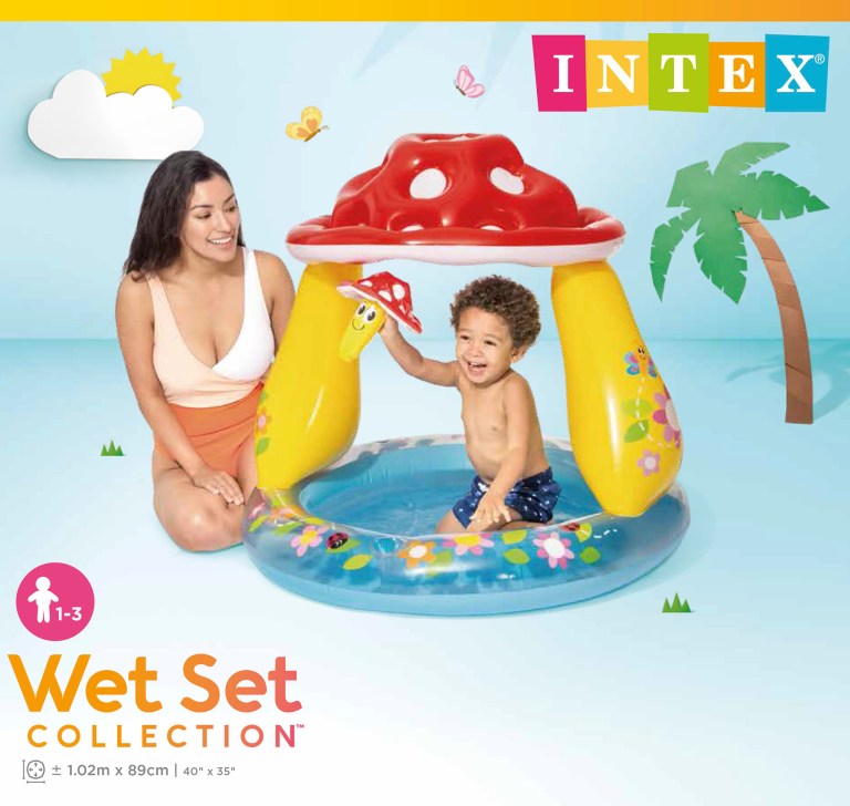 Child playing in inflatable mushroom pool.