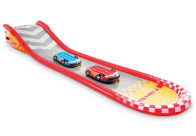 Toy race cars on inflatable track with finish line.