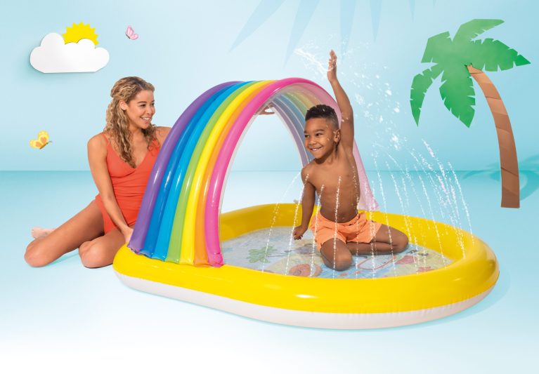 Child plays in rainbow inflatable splash pad