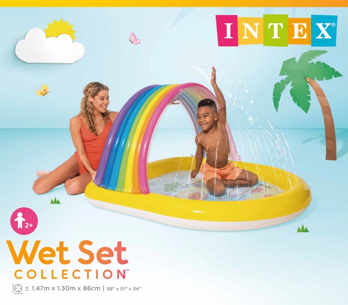 Child playing in inflatable rainbow splash pool