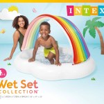 Child and adult in inflatable rainbow pool.