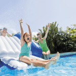 Kids enjoying water slide at pool