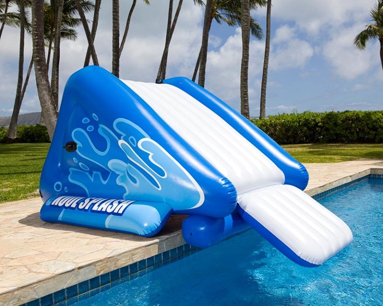 Inflatable blue pool slide next to water