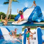 Kids enjoying inflatable pool slide with adults.