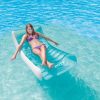 intex splash lounge 56874 Woman relaxing on float in clear blue water.