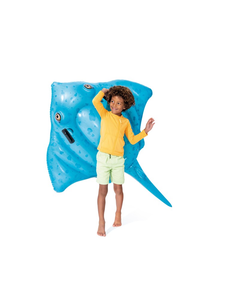 Child posing with blue inflatable stingray.
