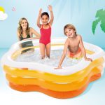Kids enjoying pool in summer setting.