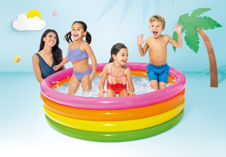 Kids playing in a rainbow inflatable pool.