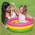 Mother and child playing in a paddling pool.