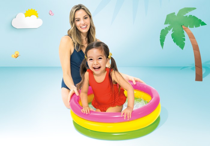 Child and adult in colourful inflatable pool.