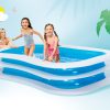 intex swim center family pool 56483 Kids playing in inflatable pool with parent watching.
