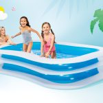 intex swim center family pool 56483 Kids playing in inflatable pool with parent watching.