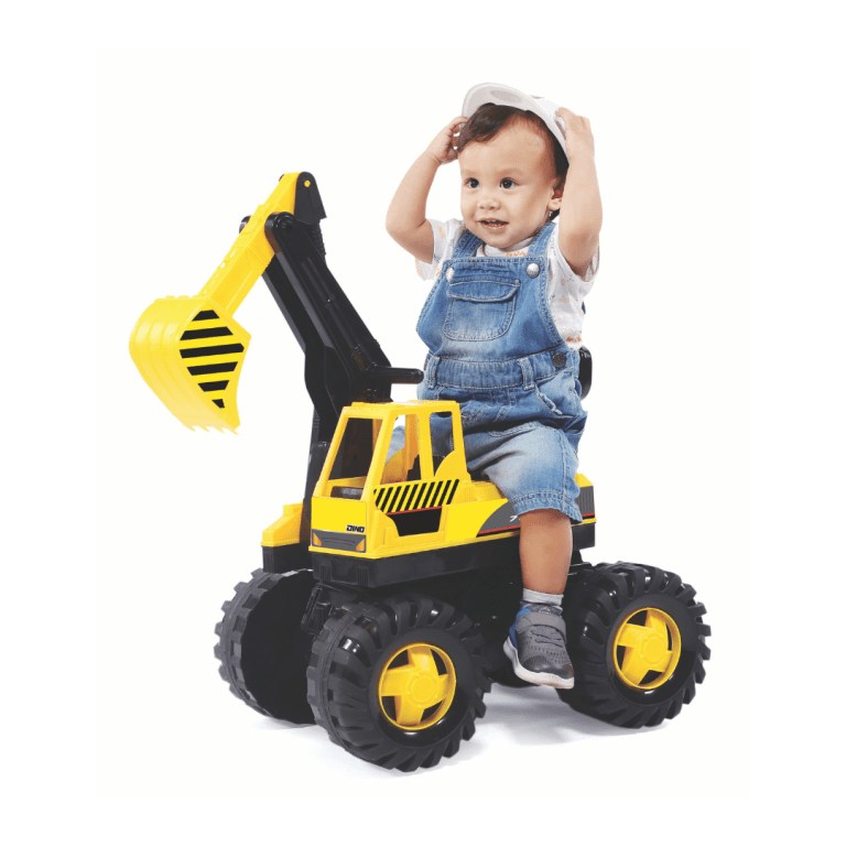Child on yellow toy digger wearing white helmet.