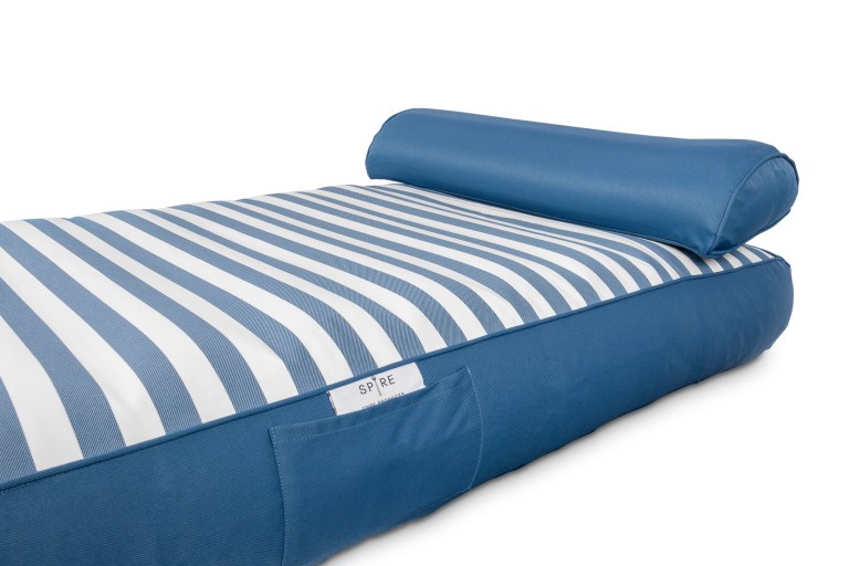 Blue and white striped outdoor cushion with headrest.