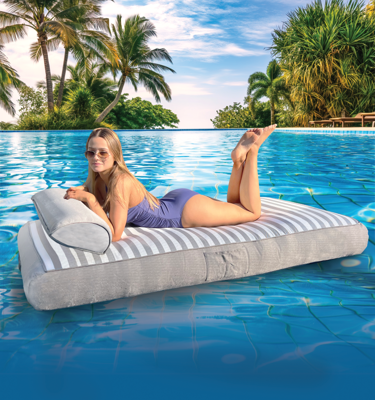 Woman relaxing on inflatable pool mattress, tropical background.