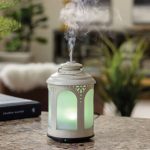 chelsea lantern ultrasonic aroma diffuser Aromatic diffuser emitting mist on table.