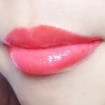 Glossy pink lips close-up.