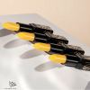 Four yellow lipsticks in black cases on display.
