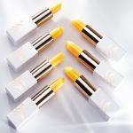 Yellow lipsticks arranged in a diagonal pattern.
