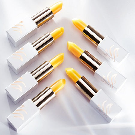 Yellow lipsticks arranged in a diagonal pattern.