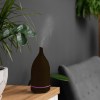 milano decor aroma diffuser 100ml ultrasonic humidifier purifier and 3 pack oils dark wood Aromatherapy diffuser with steam in modern living room.