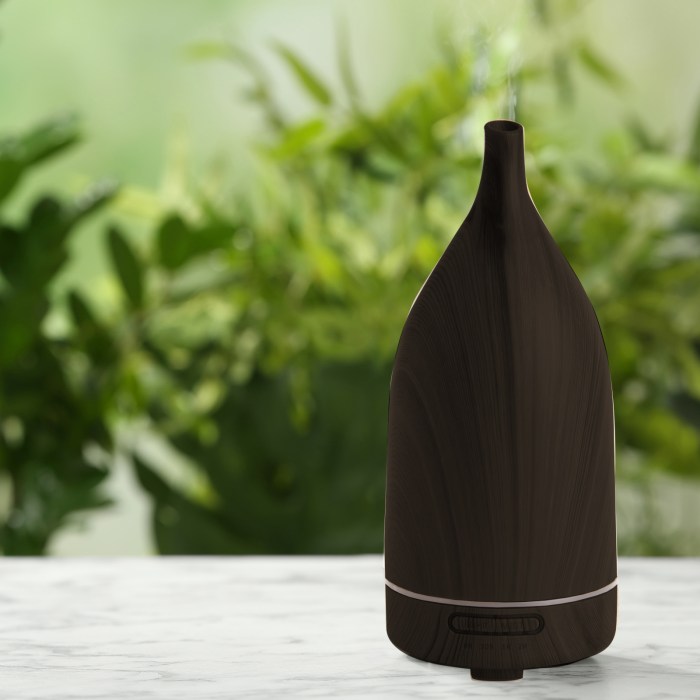 milano decor aroma diffuser 100ml ultrasonic humidifier purifier and 3 pack oils dark wood Brown aromatherapy diffuser with green plants background.