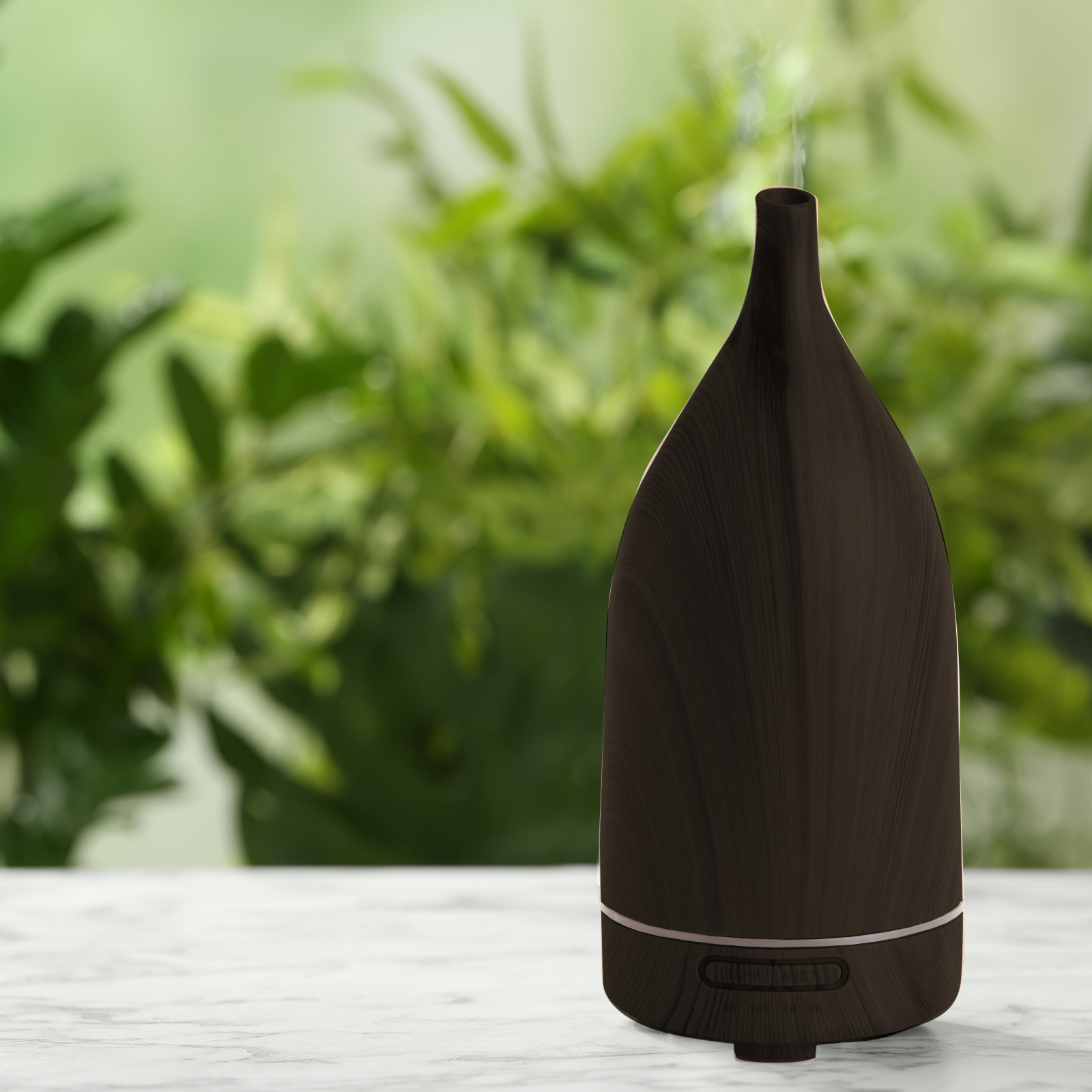 Brown aromatherapy diffuser with green plants background.
