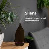 milano decor aroma diffuser 100ml ultrasonic humidifier purifier and 3 pack oils dark wood Aroma diffuser on table, enhancing mood and relaxation.