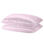 Two pink silk pillows stacked together.