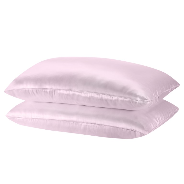 Two pink silk pillows stacked together.