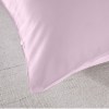 royal comfort mulberry soft silk hypoallergenic pillowcase twin pack 51 x 76cm lilac Purple silk pillowcase on beige fabric surface.