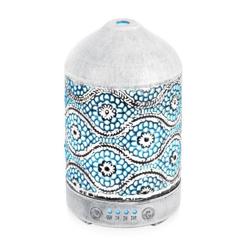 Decorative oil diffuser with intricate blue pattern.