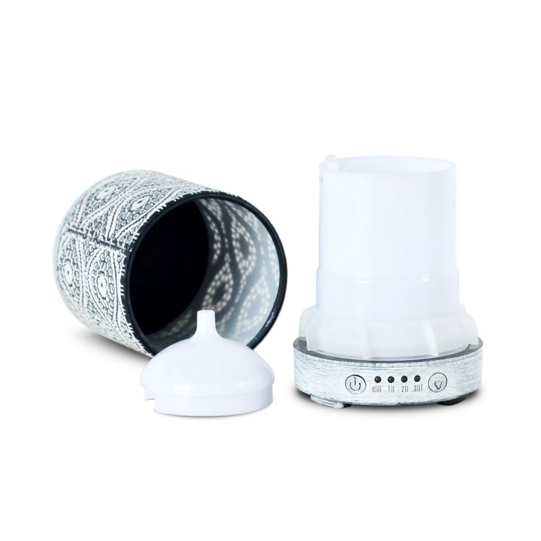Decorative essential oil diffuser with intricate design.