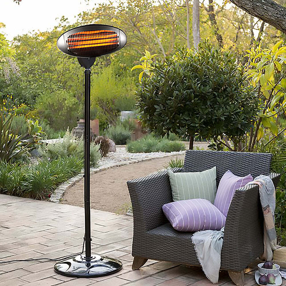 Outdoor heater beside patio chair with cushions.