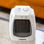 Portable heater with control knobs and mesh front.