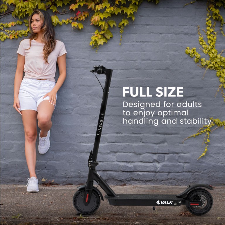 valk 400w electric scooter, 37v folding e scooter with suspension, for adults, synergy 5 mkii black Woman with electric scooter in urban setting.